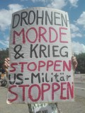 Schild eines Demoteilnehmers vor der US Air Base Rastein